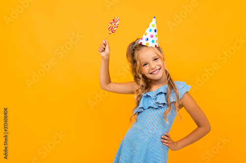 Pretty caucasian teengager girl have birthdau party isolated on orange background