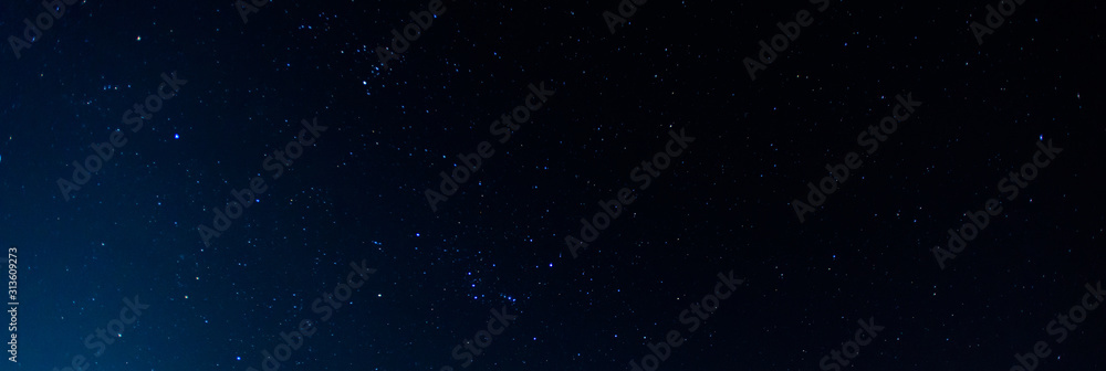 Fototapeta premium Panorama blue night sky milky way and star on dark background.Universe filled with stars, nebula and galaxy with noise and grain.Photo by long exposure and select white balance.selection focus.amazing