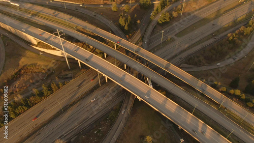 AERIAL Spectacular drone view of a bustling interstate turnpike on sunny evening