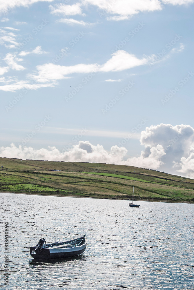 Spectacular view on a lake with a boat in the foreground, Ireland