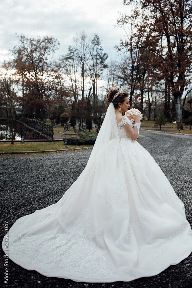 Beauty, fashion. The beautiful woman posing in a wedding dress. Beautiful wedding bouquet with fresh flowers on a wedding day. Wedding. Beautiful bride.