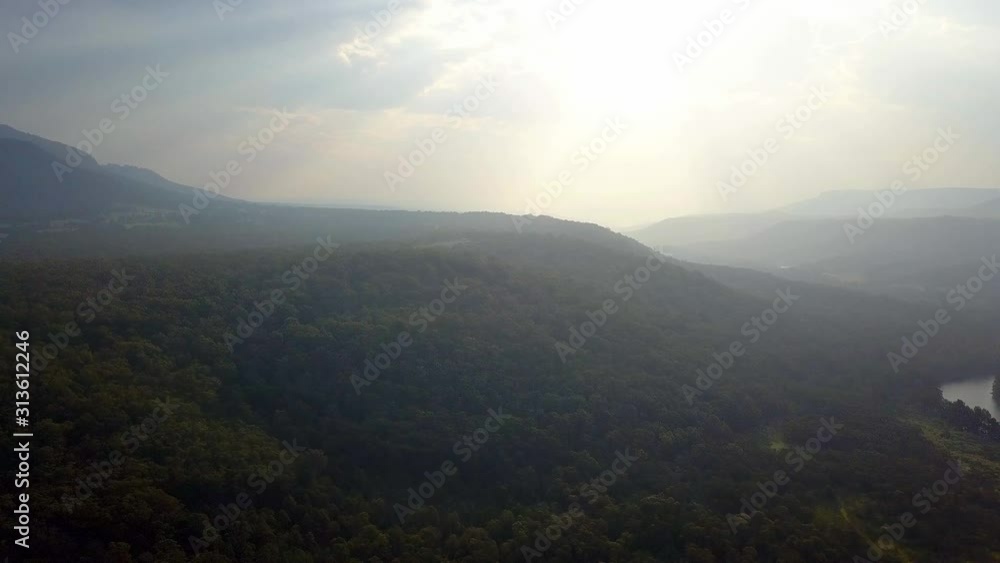 Mountains and sun shining through bush fire smokey air in Warragamba Australia, drone pedestal lift shot Mountains and sun shining through bush fire smokey air in Warragamba Australia, drone pedestal lift shot