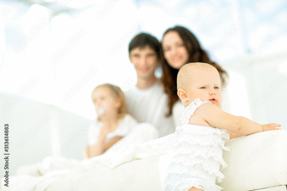 happy little baby on blurred background of the famil happy little baby on blurred background of the famil