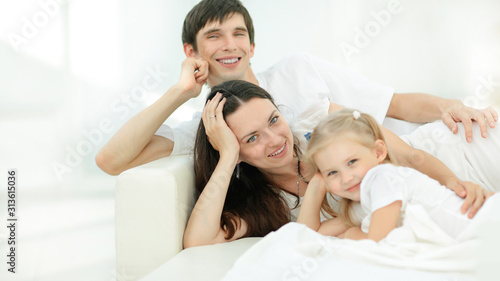 happy family lying on the sofa on Sunday.