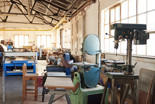 Fotografija Drill press and band saw inside of a woodworking shop