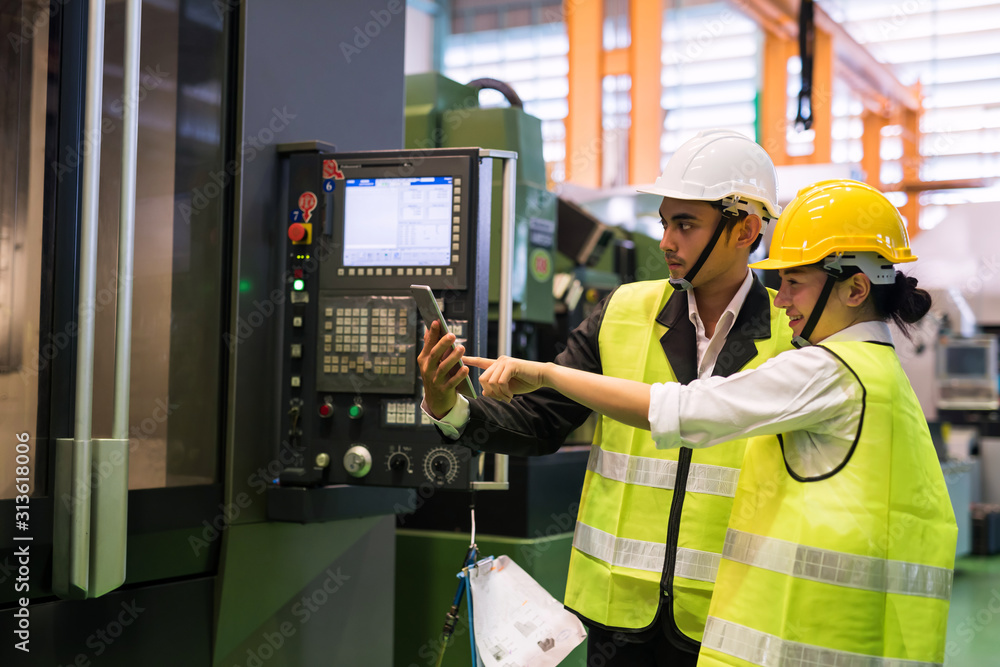 Factory workers check productivity in tablet Factory workers check productivity in tablet