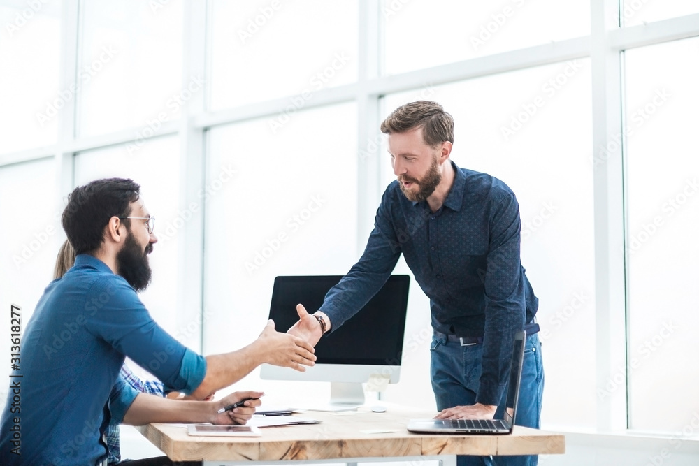 business people shaking hands over the Desk - obrazy, fototapety, plakaty 