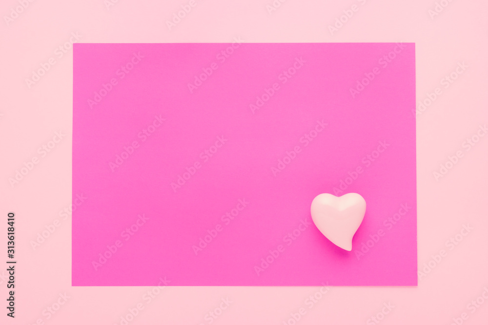 pastel pink background with a heart and copy space