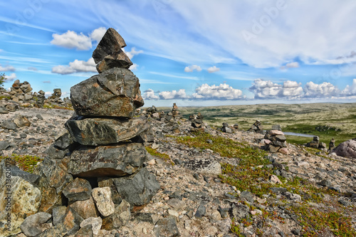 Touristic pyramid balanced stack of stones at the tundra © Lianna Art