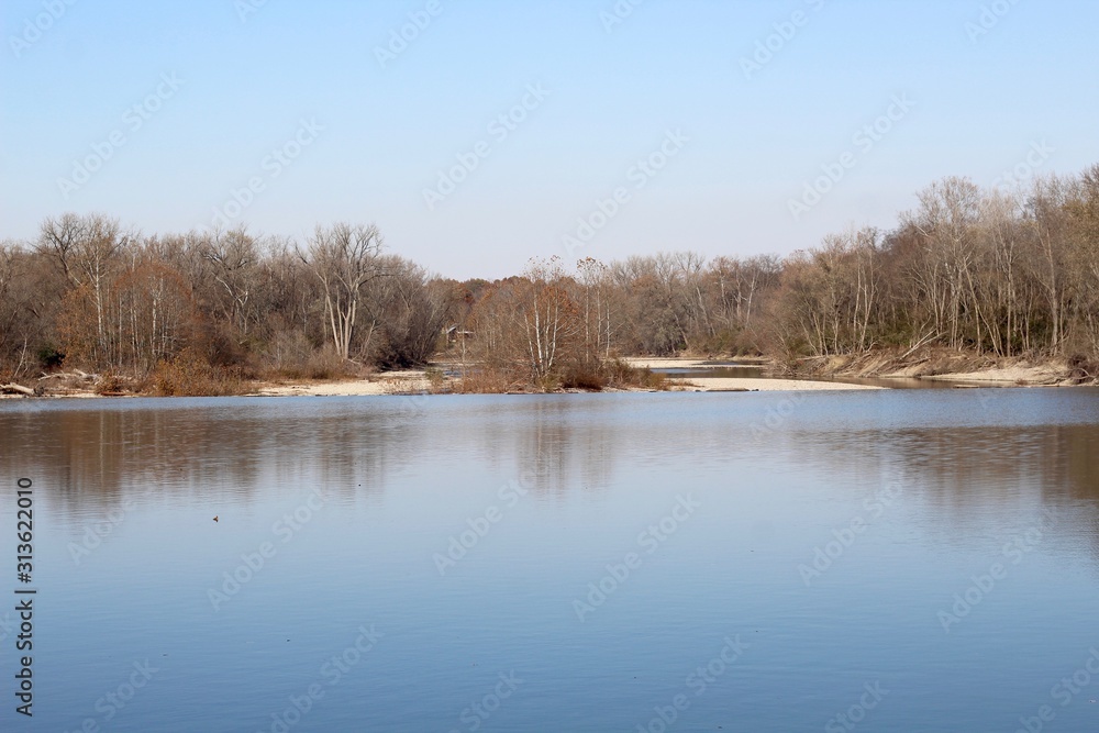 A view of the flowing river on a sunny autumn day. A view of the flowing river on a sunny autumn day.