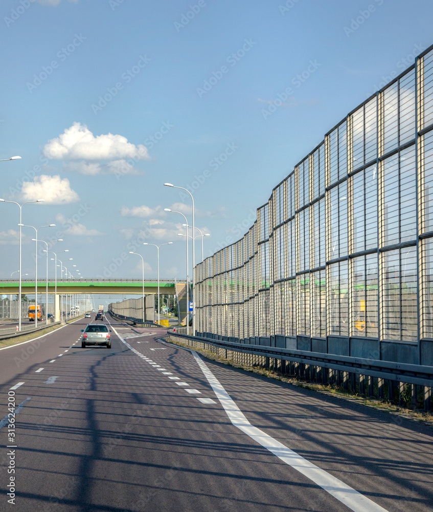 high transparent barrier on the highway for protection against noise
