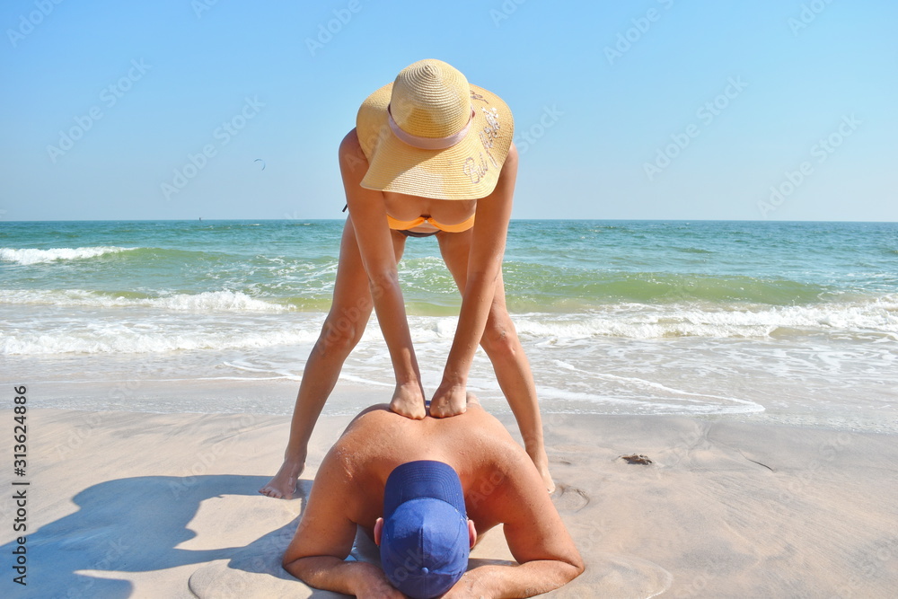 Erotic massage on beach. Girl in swimsuit getting massage. Girl masseuse on  sea. Beautiful woman in bikini massaging body of man. Stock Photo | Adobe  Stock