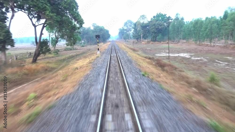 Train running on track on a railway or railroad Train running on track on a railway or railroad