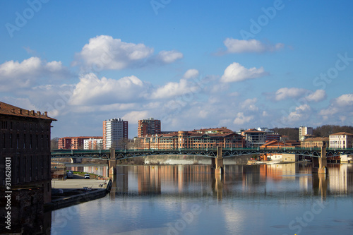 Landscape of a city and a bridge in France with reflection of the buildings in the river