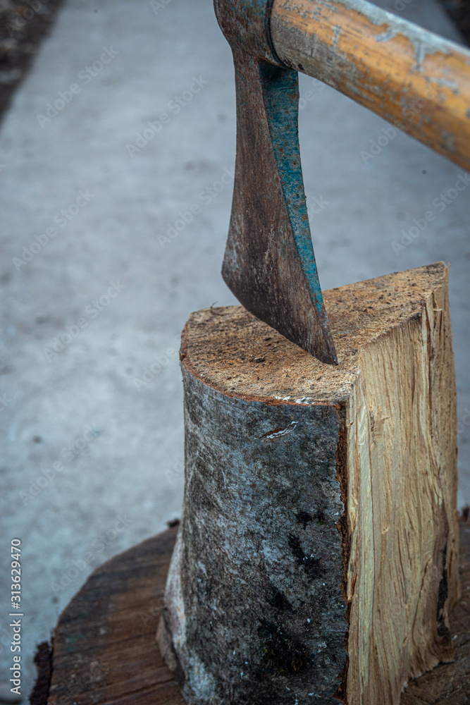 splittting wood with an old hand axe. ready for winter. splittting wood with an old hand axe. ready for winter.