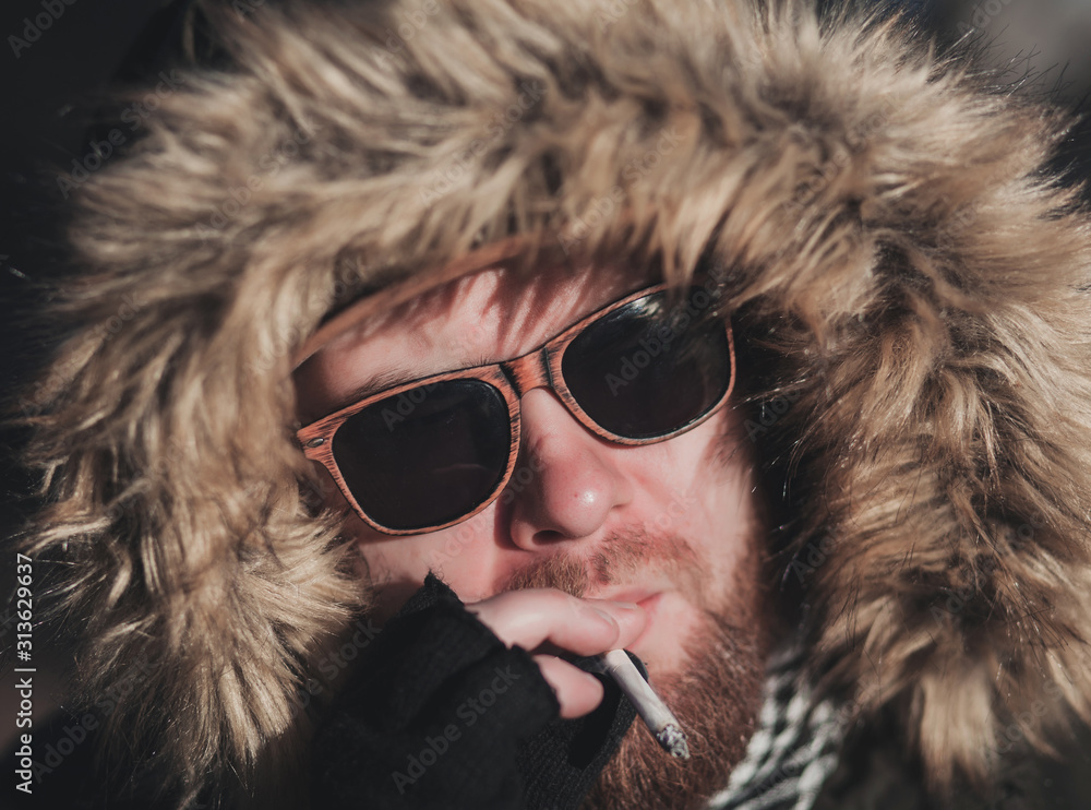Handsome hipster stylish man smoking outside in urban setting, Handsome hipster stylish man smoking outside in urban setting,