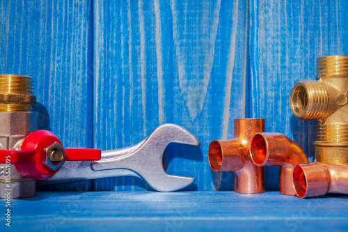 Spare parts and accessories for plumbing repair on blue vintage wooden boards