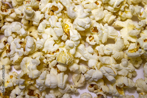 Popcorn on a white table. The texture of popcorn.