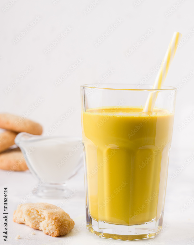 healthy latte with turmeric and spices on a white plate next to milk and cookies. breakfast healthy latte with turmeric and spices on a white plate next to milk and cookies. breakfast