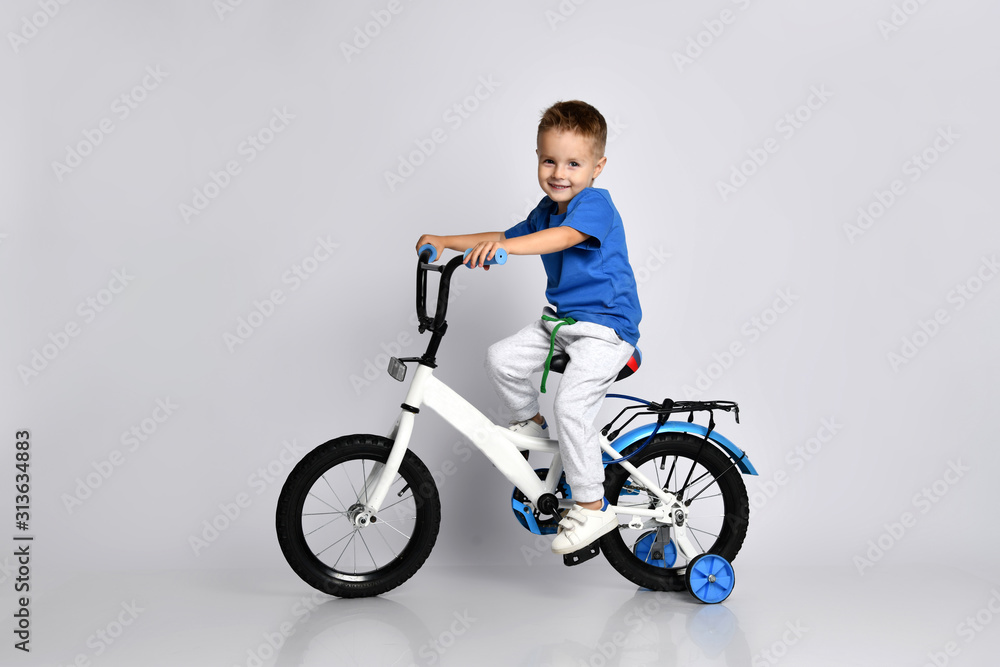 young boy happily riding on a bicycle on isolated background young boy happily riding on a bicycle on isolated background