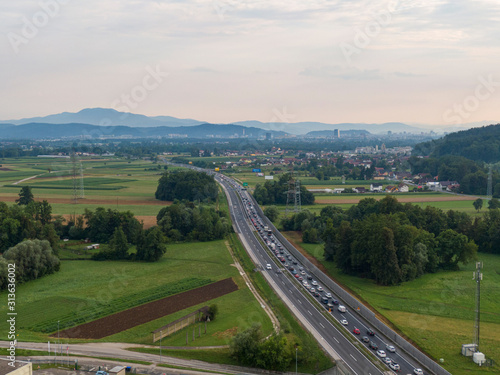 AERIAL: Flying above heavy highway traffic slowly moving towards capital city