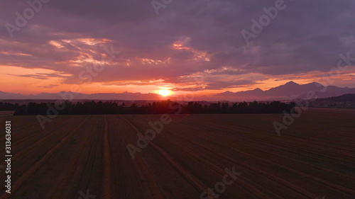 DRONE: Golden sunrise gently illuminates the tranquil farmland in Slovenia.