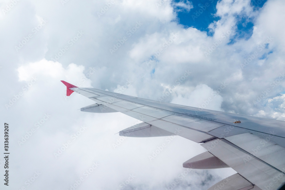 Look through the plane window and white cloud and blue sky Look through the plane window and white cloud and blue sky