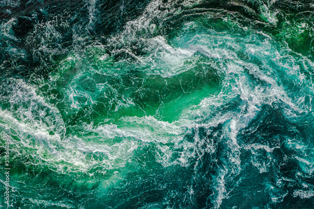 Abstract background. Waves of water of the river and the sea meet each other during high tide and low tide. Whirlpools of the maelstrom of Saltstraumen, Nordland, Norway
