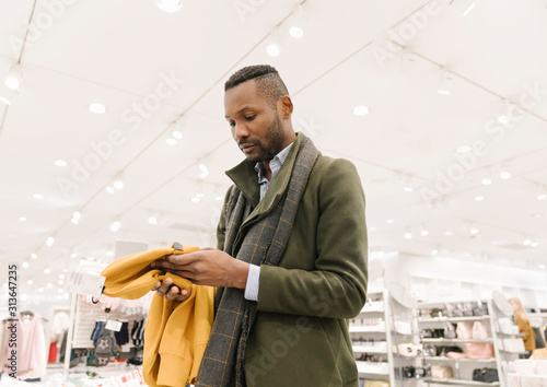 Stylish man shopping in a clothes store
