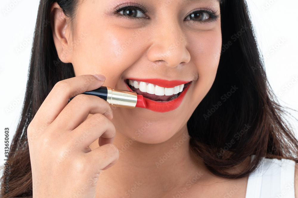 Close up face of beauty Asian woman is applying red lipstick and makeup. Concept of cosmetic and skin care Close up face of beauty Asian woman is applying red lipstick and makeup. Concept of cosmetic and skin care