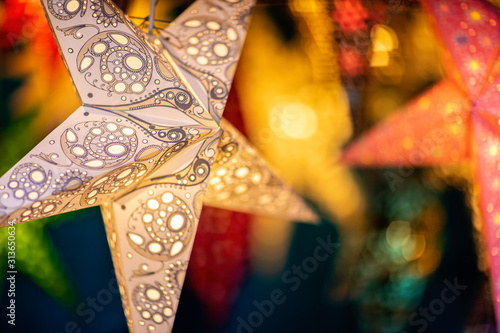 Christmas Paper Stars on sale at market stall at Bath Christmas Market, Bath, Somerset, UK on 13 December 2019