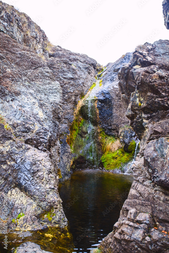  waterfall flowing through big rocks