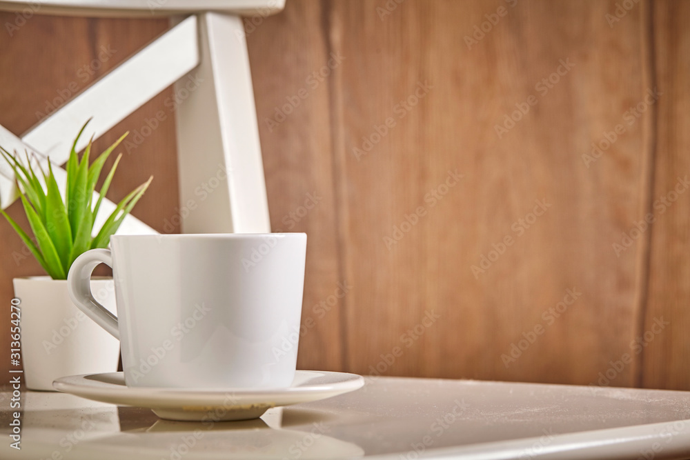 White cup of hot coffee or tea on wooden background. Close up. background White cup of hot coffee or tea on wooden background. Close up. background