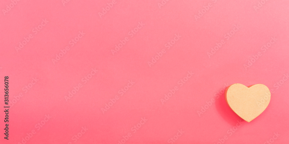 Heart gift box on a pink paper background