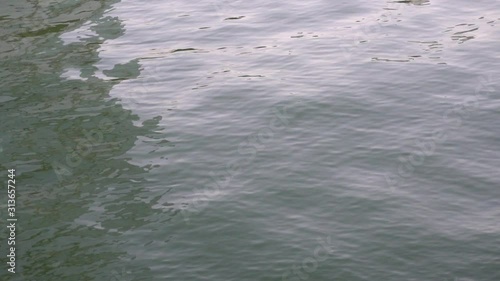 Slow motion of light refracting off ripples in the canal at public park, Bangkok, Thailand