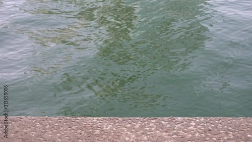 Slow motion of light refracting off ripples in the canal at public park, Bangkok, Thailand