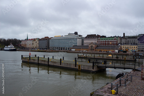 Pier and promenade in the city of Helsinki in Finland on a warm day of snowless December with unfrozen water.