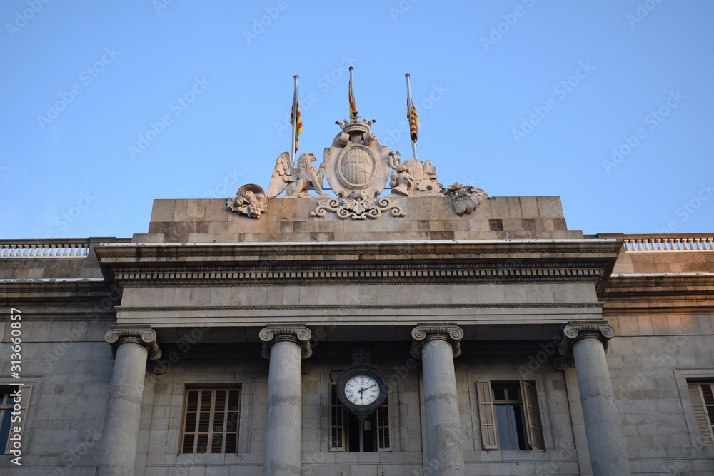 Classical Stone Facade & Columns of Public Building with Flags & Clock in Barcelona 