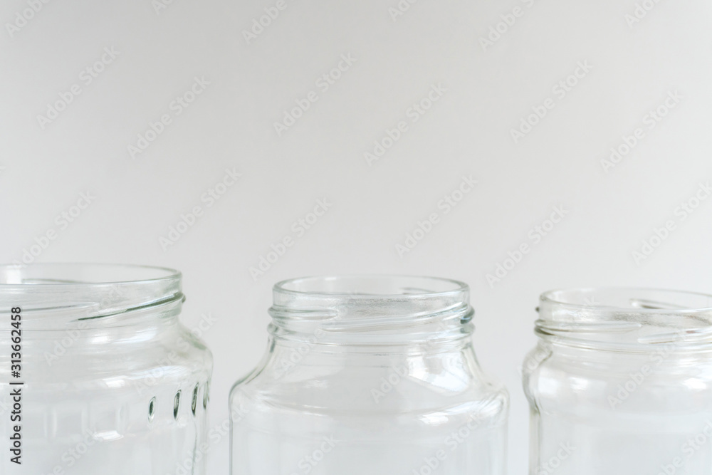 Glass jars at gray monochrome background. Zero waste concept. Glass jars at gray monochrome background. Zero waste concept.