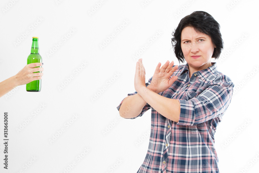 Anti alcohol concept - woman rejects a bottle of alcohol Anti alcohol concept - woman rejects a bottle of alcohol