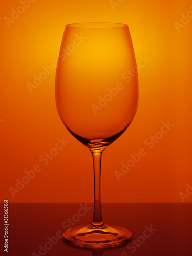 glass of wine on orange background