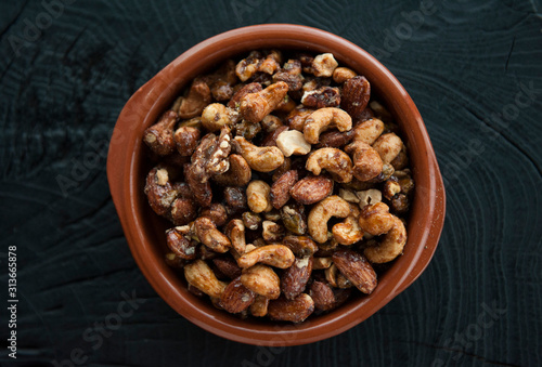 Roasted nuts in ceramic bowl photo