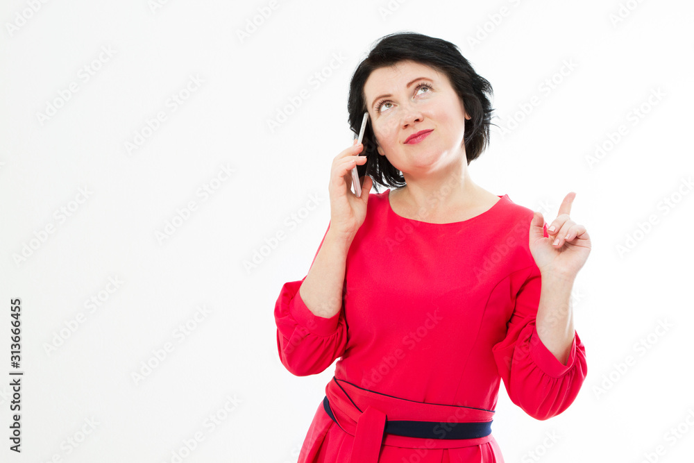 Brunette middle age woman pointed up and talking on phone copy space Brunette middle age woman pointed up and talking on phone copy space