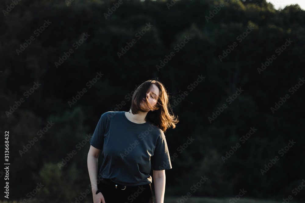 Beautiful portrait of a young stylish woman on a sunny day in au Beautiful portrait of a young stylish woman on a sunny day in au