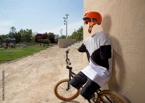 Invisible bmx rider relaxing against a wall photo