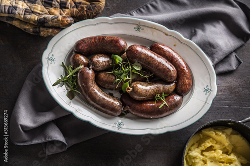 Roasted sausages in pan with rosemary. Traditional european food bratwurst jaternice or jitrnice photo