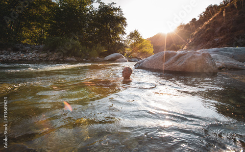 Man relaxing in the Middle Fork Kaweah River photo