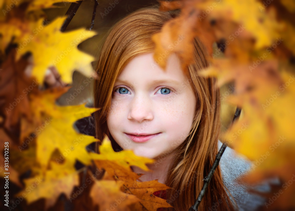 Red Haired Girl Looking Through Yellow Fall Leaves Red Haired Girl Looking Through Yellow Fall Leaves