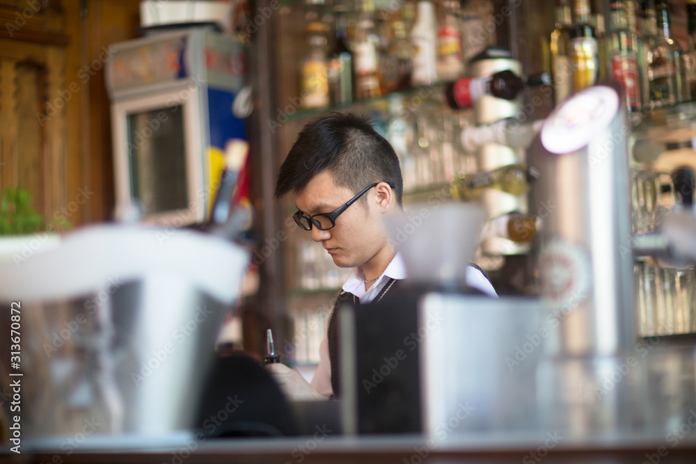young asia waiter in a bar young asia waiter in a bar