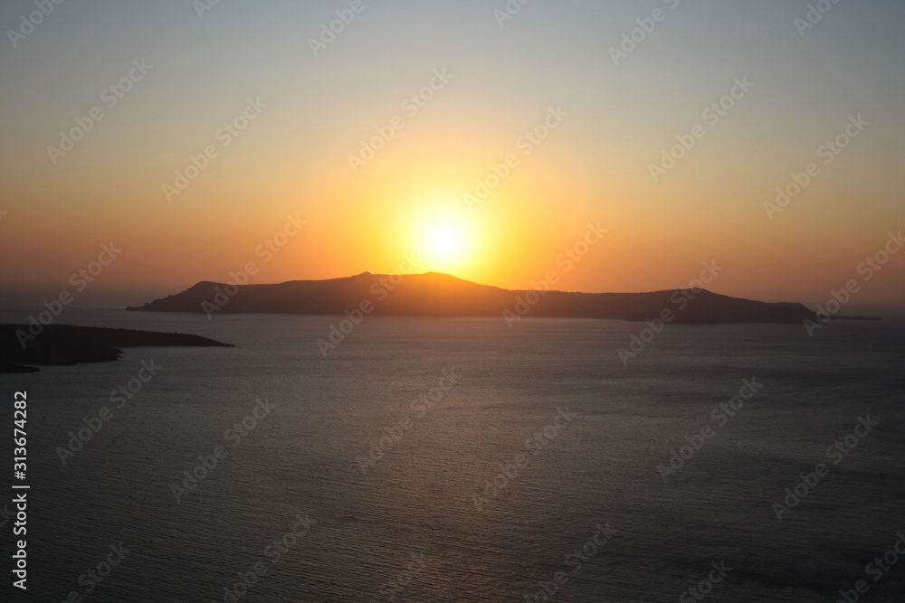 Sunset over the island of Nea Kameni as seen from Santorini Sunset over the island of Nea Kameni as seen from Santorini